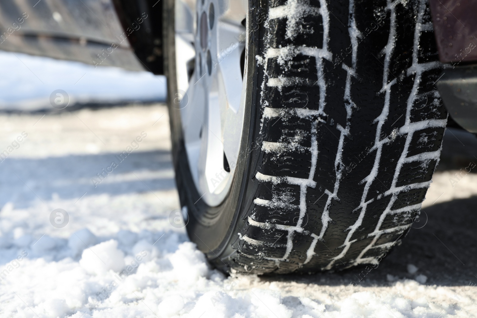 Photo of Car with winter tires on snowy road, closeup view