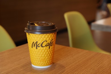 MYKOLAIV, UKRAINE - AUGUST 11, 2021: Hot McDonald's drink on table in cafe. Space for text