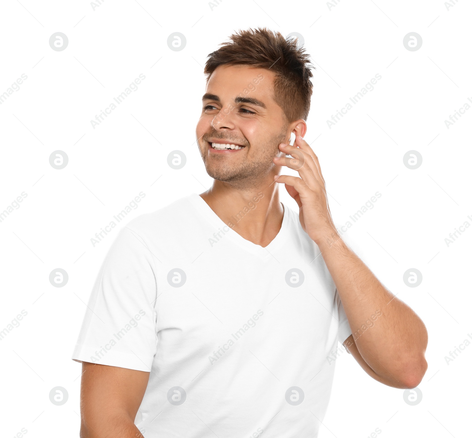 Photo of Happy young man listening to music through wireless earphones on white background