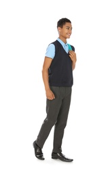 Full length portrait of African-American boy in school uniform with backpack on white background