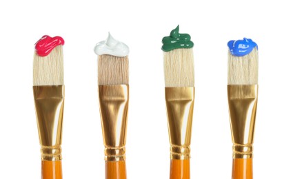 Set of different brushes with paints on white background