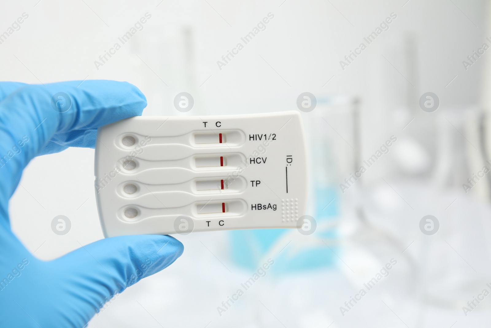 Photo of Doctor holding disposable express test for hepatitis indoors, closeup