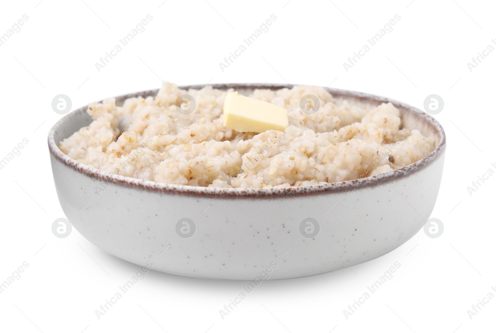 Photo of Delicious barley porridge with butter in bowl isolated on white