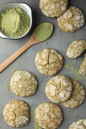 Photo of Tasty matcha cookies and powder on grey table, flat lay