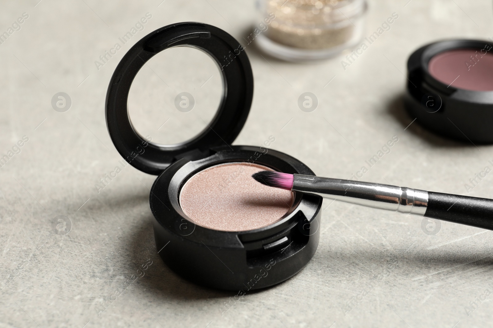 Photo of Eye shadow with makeup brush on table