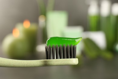 Aloe vera toothpaste on brush against blurred background, closeup