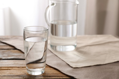 Photo of Glassware of fresh water on table indoors. Space for text