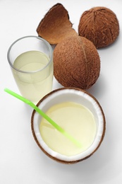 Photo of Composition with coconuts and drink on white background