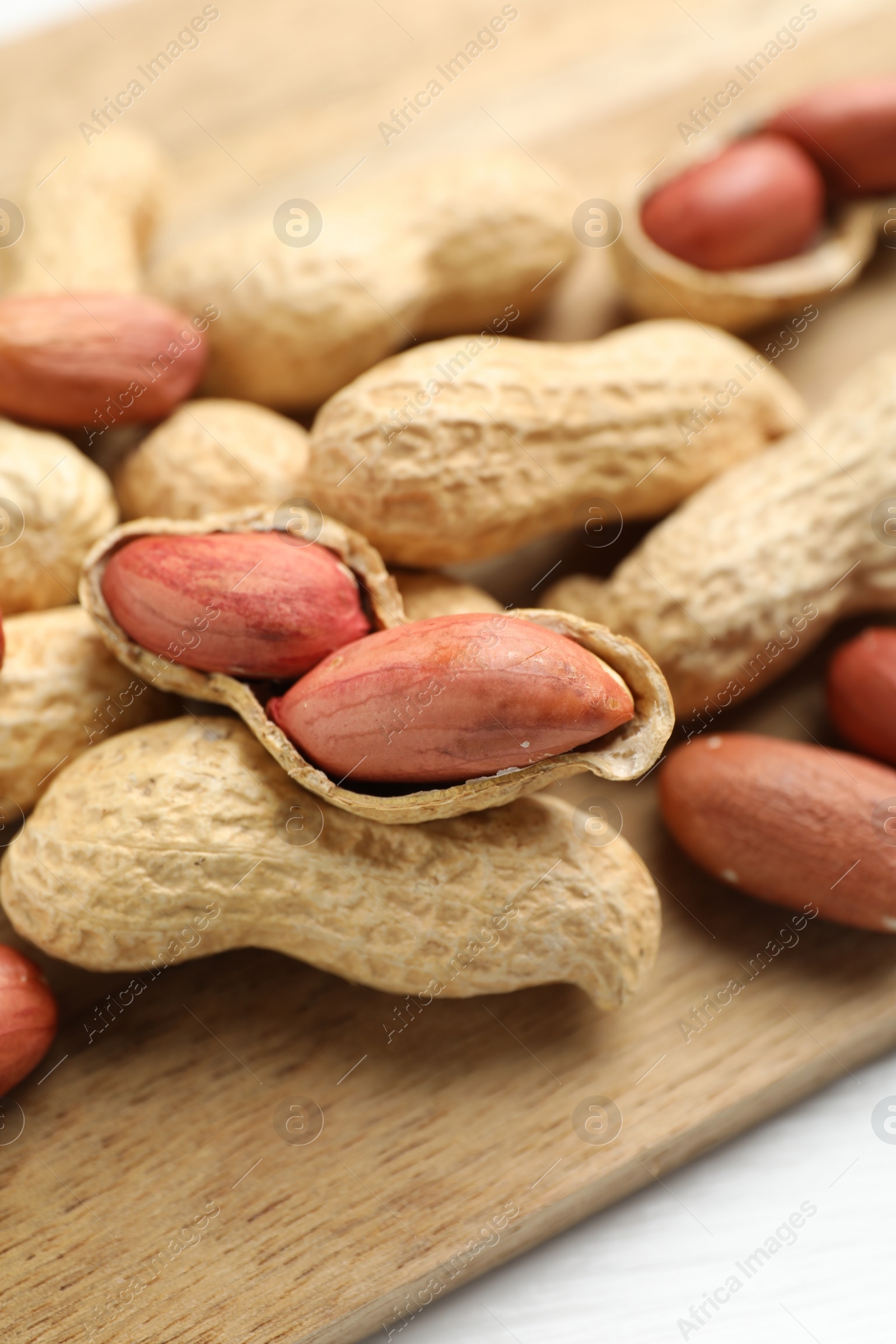 Photo of Fresh unpeeled peanuts on table, closeup view