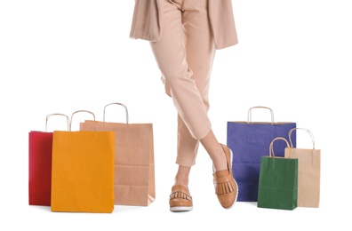 Photo of Young woman with shopping bags on white background, closeup