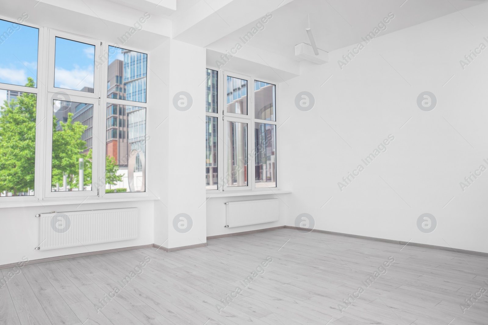 Photo of Modern office room with white walls and windows. Interior design