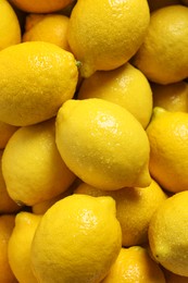 Photo of Fresh lemons with water drops as background, closeup