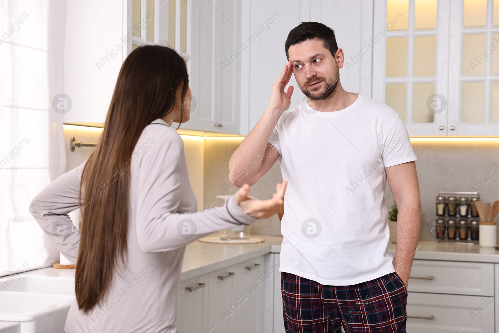 Photo of Emotional couple arguing in kitchen. Relationship problems