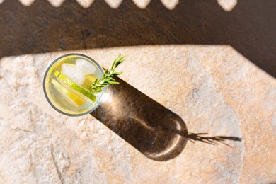 Summer refreshing lemonade on light brown table, top view. Space for text