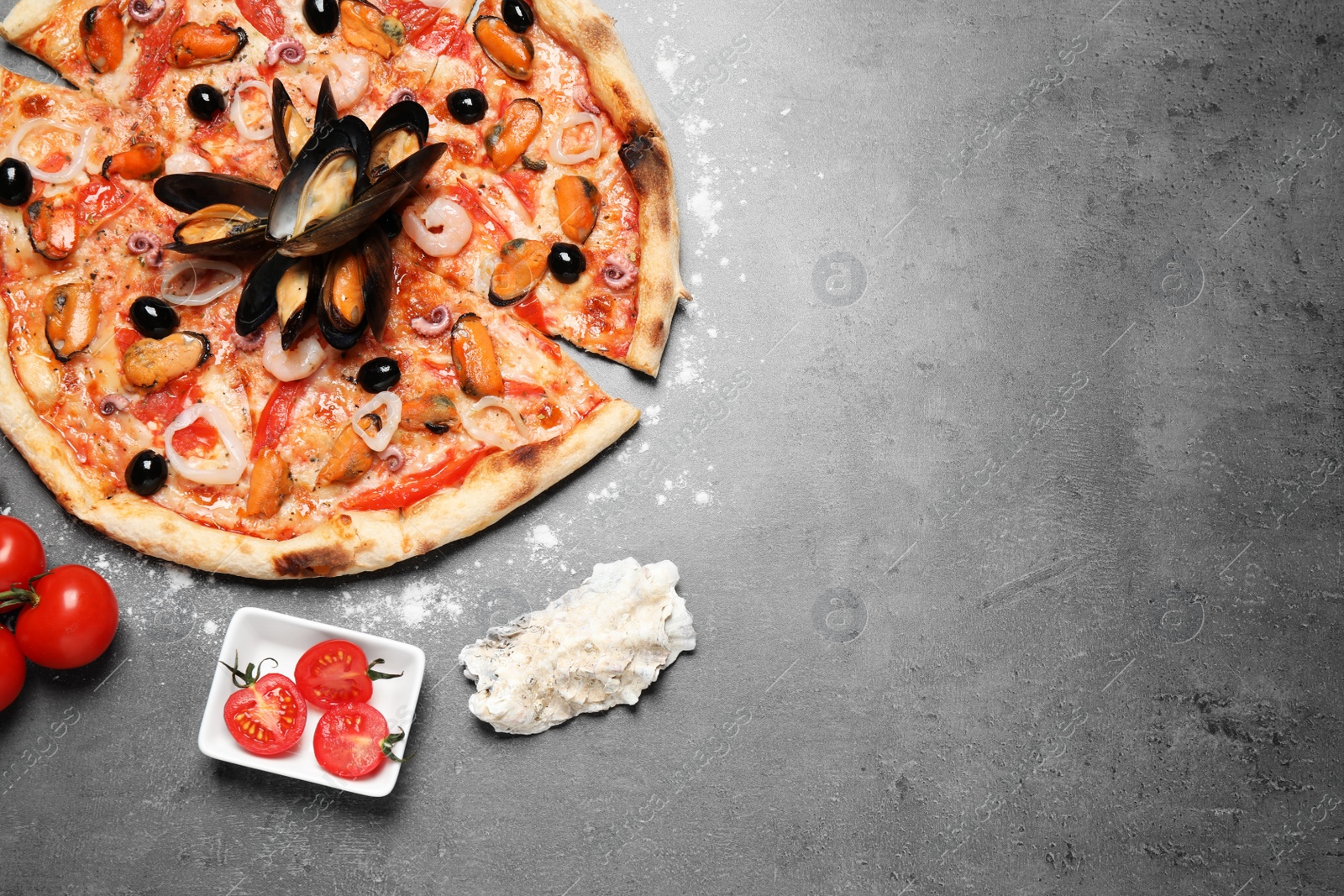 Photo of Tasty pizza with seafood and tomatoes on grey table, flat lay. Space for text