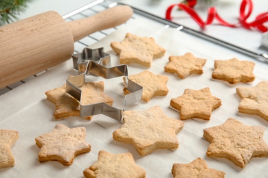 Photo of Tasty homemade Christmas cookies on baking parchment