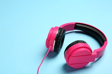 Photo of Stylish headphones on color background. Space for text