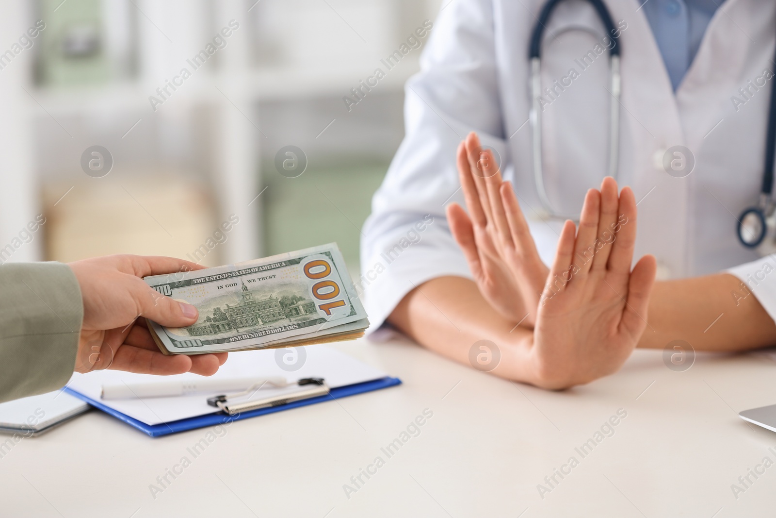 Photo of Doctor rejecting bribe in clinic, closeup. Corrupted medicine