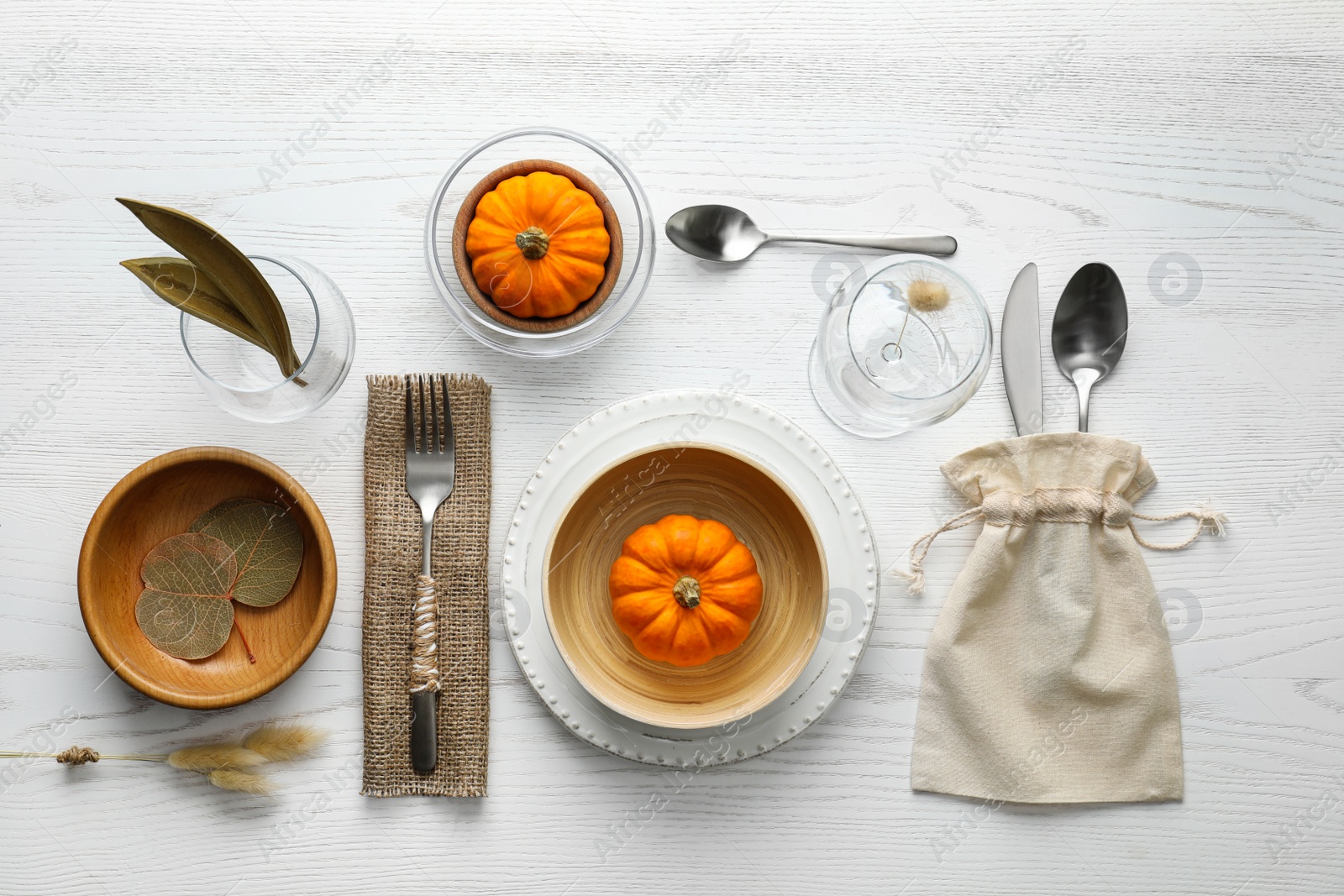 Photo of Autumn table setting with pumpkins on white wooden background, flat lay