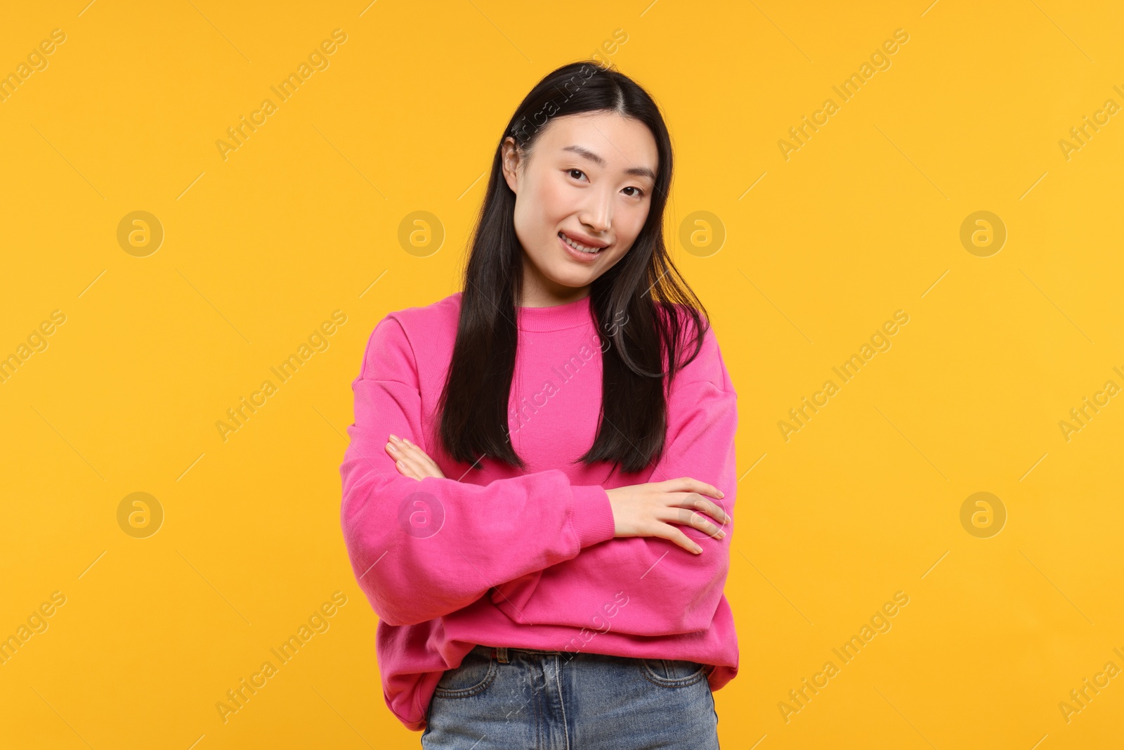 Photo of Portrait of smiling woman on orange background