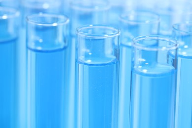 Test tubes with light blue reagents, closeup. Laboratory analysis
