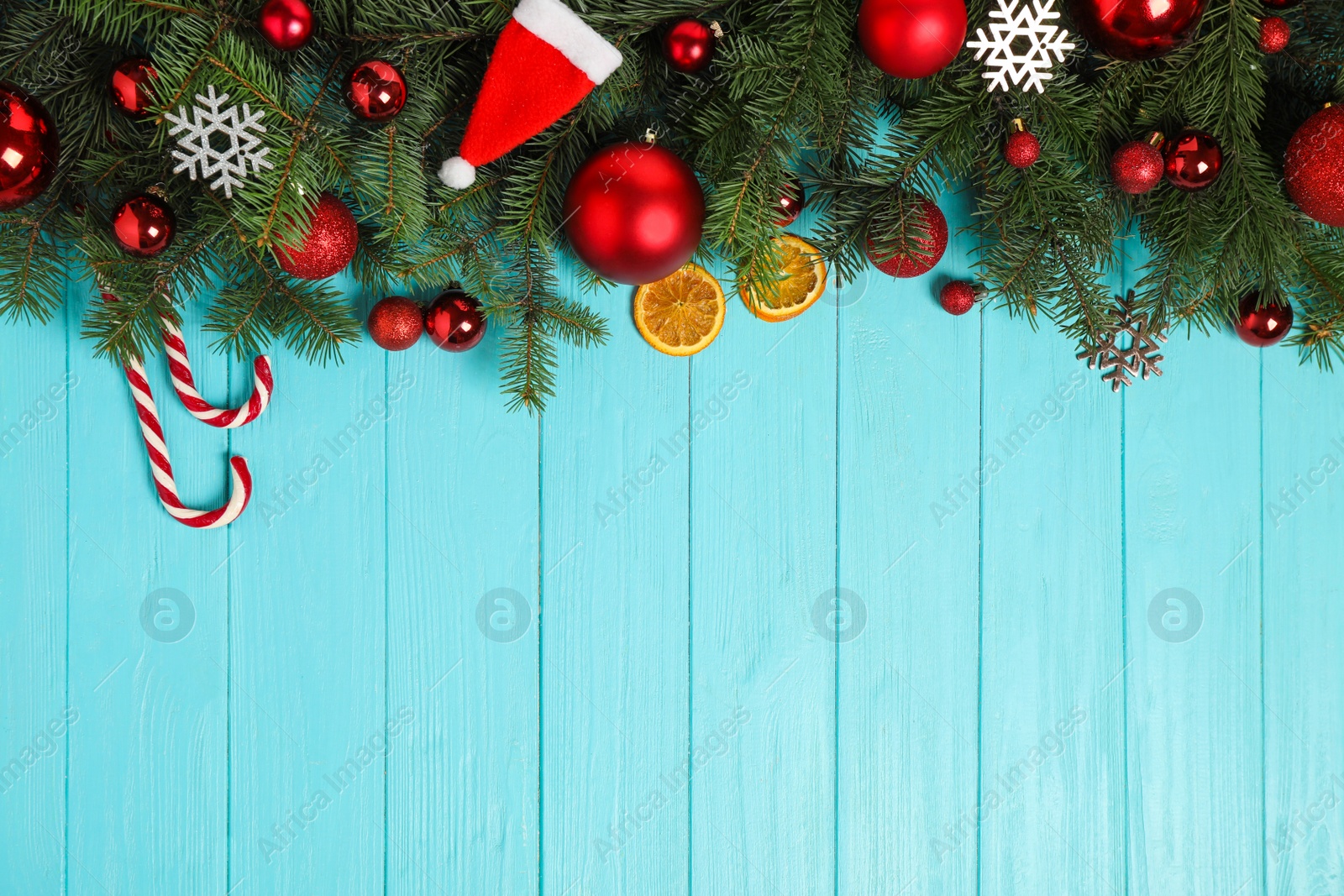 Photo of Fir branches with Christmas decoration on light blue wooden background, flat lay. Space for text