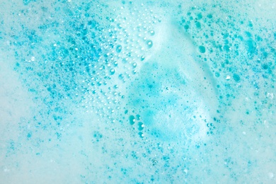 Photo of View of foam after dissolving color bath bomb in water, closeup