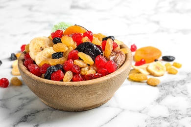 Bowl with different dried fruits on marble background. Healthy lifestyle