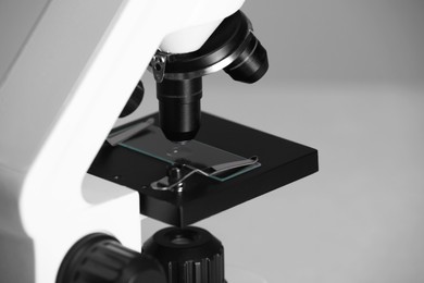 Photo of Modern microscope on grey background, closeup. Medical equipment