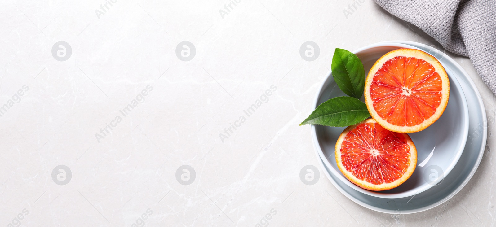 Photo of Slices of fresh ripe red orange on light table, flat lay. Space for text