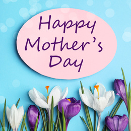 Image of Card with phrase HAPPY MOTHER'S DAY and flowers on light blue background, flat lay