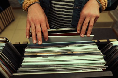 Image of Man choosing vinyl records in store, closeup