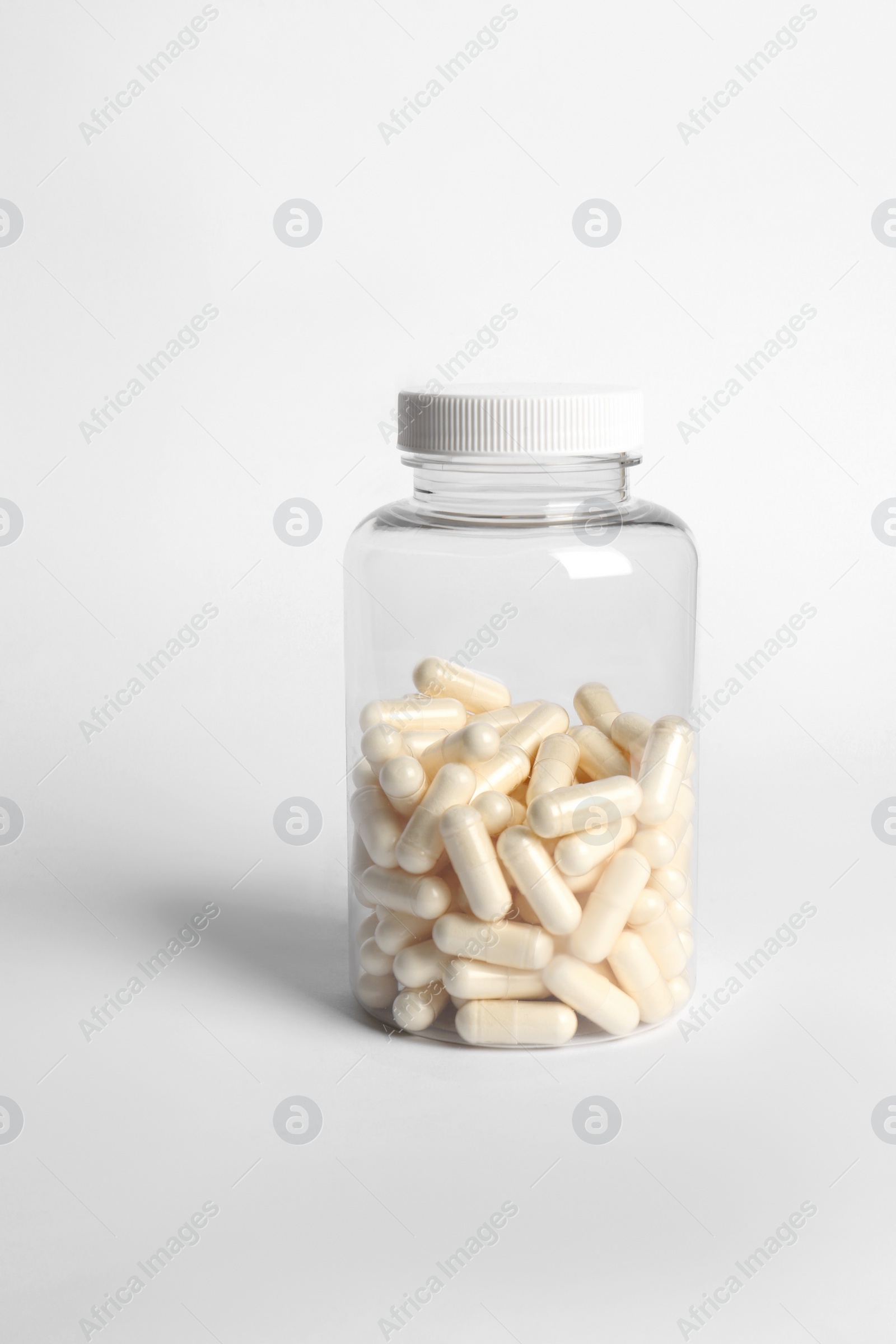 Photo of Transparent bottle with pills on white background