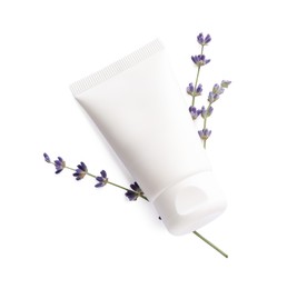 Tube of hand cream and lavender on white background, top view