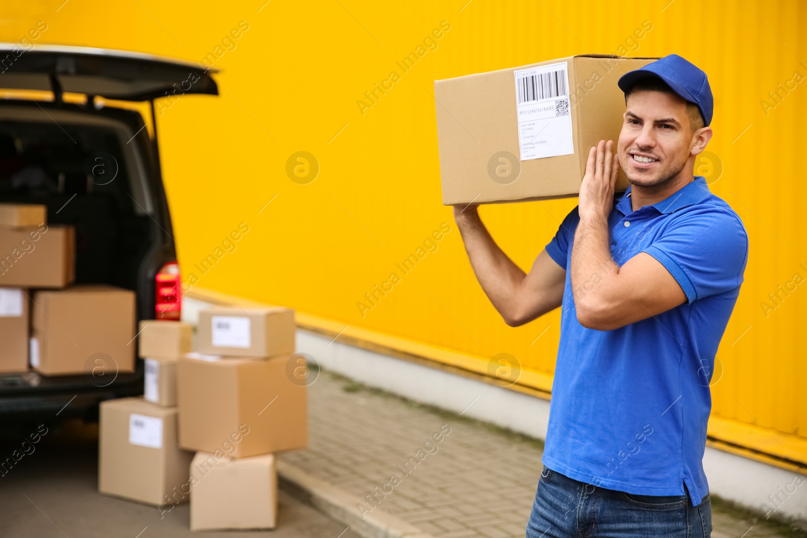 Photo of Courier with parcel near delivery van outdoors. Space for text