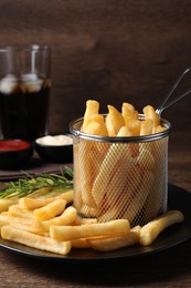 Photo of Delicious French fries on wooden table, closeup