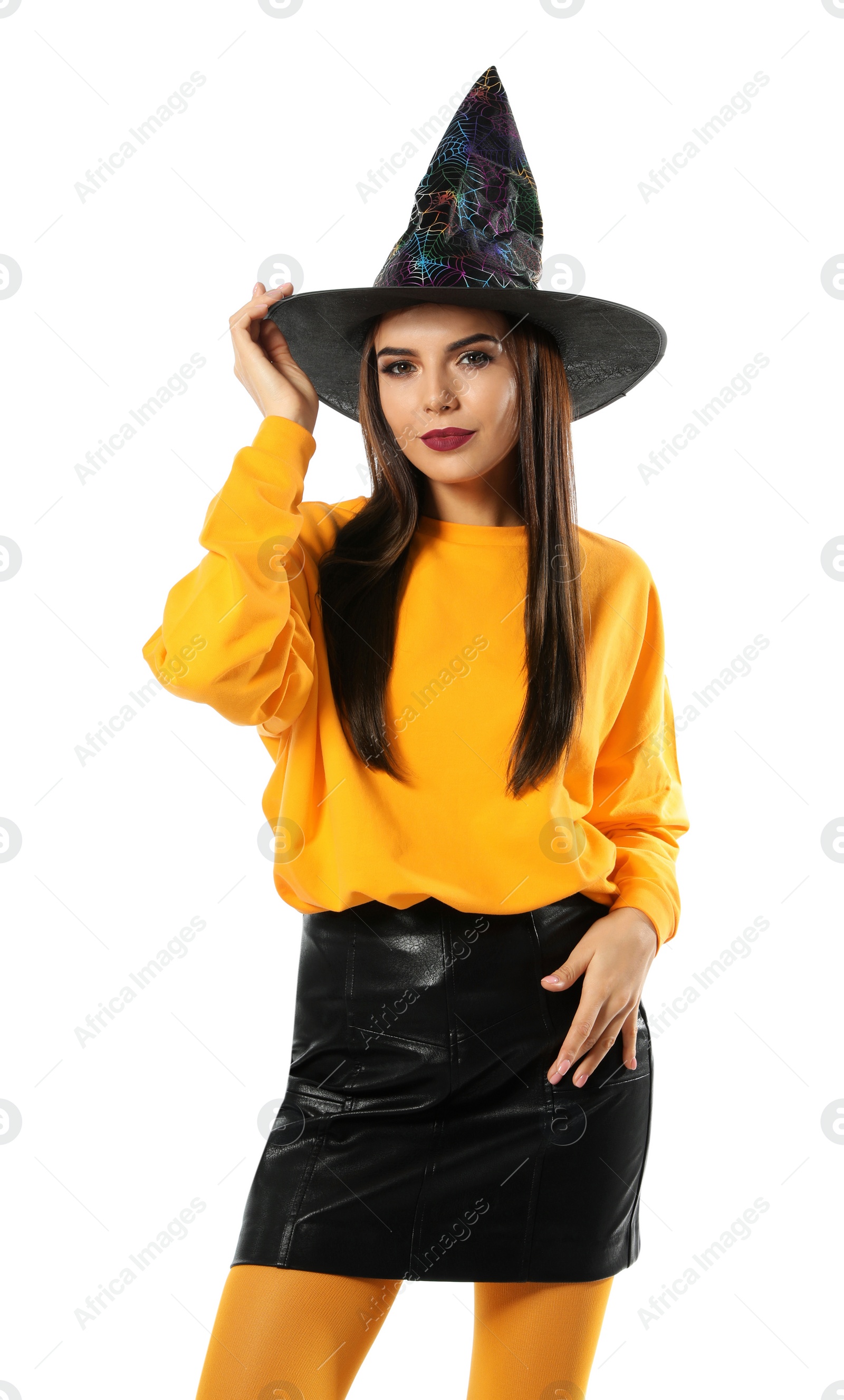 Photo of Beautiful young woman wearing witch costume for Halloween party on white background