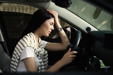 Photo of Stressed young woman driver's seat of modern car