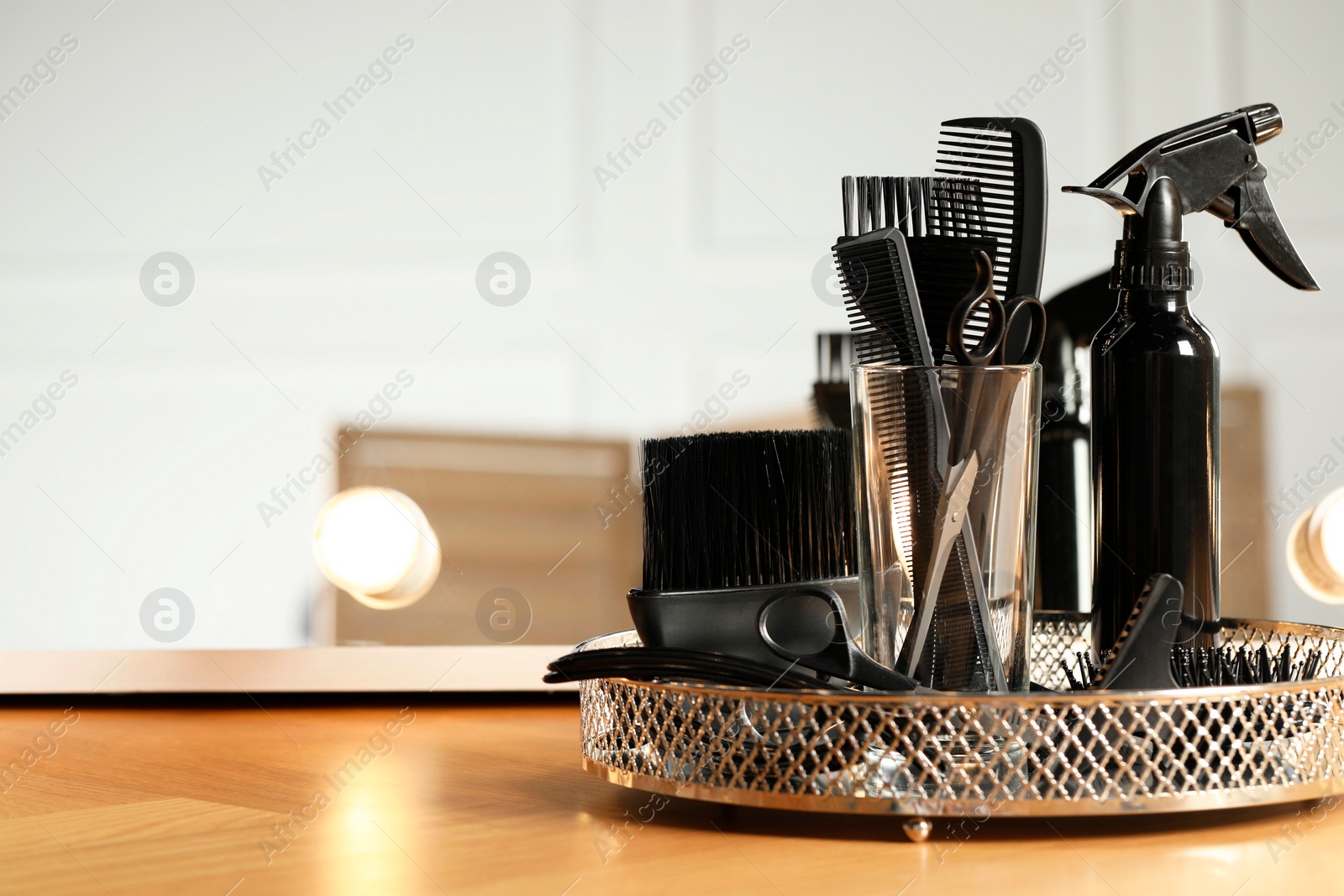 Photo of Set of hairdresser tools on table in salon. Space for text