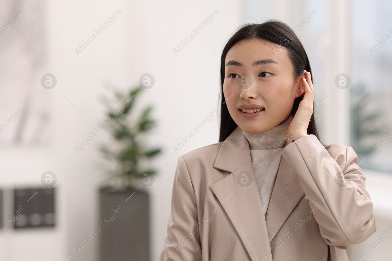 Photo of Portrait of smiling businesswoman in office. Space for text