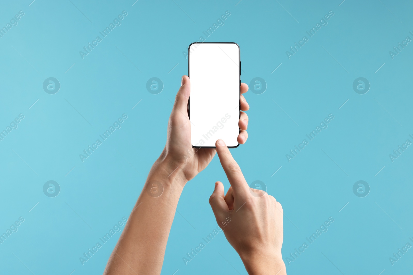 Photo of Man using smartphone with blank screen on light blue background, closeup. Mockup for design