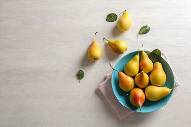 Photo of Flat lay composition with ripe pears on light background. Space for text