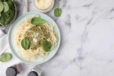 Photo of Tasty pasta with spinach, cheese and sauce on white marble table, flat lay. Space for text