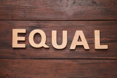 Photo of Word Equal made of wooden letters on table, flat lay