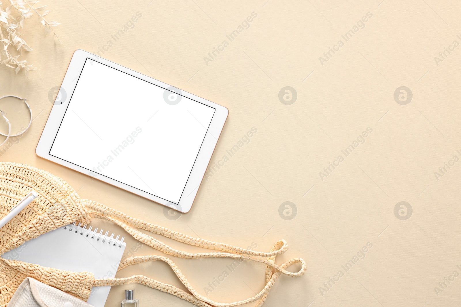 Photo of Flat lay composition with modern tablet on beige background. Space for text