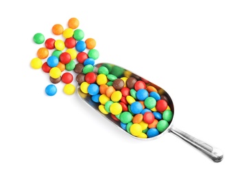 Photo of Scoop with colorful candies on white background, top view