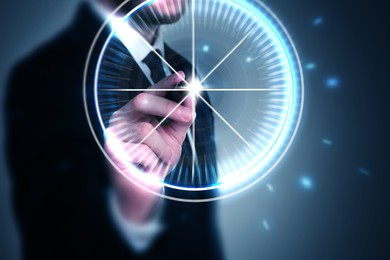Image of Businessman aiming at virtual screen with digital target against dark blue background, closeup