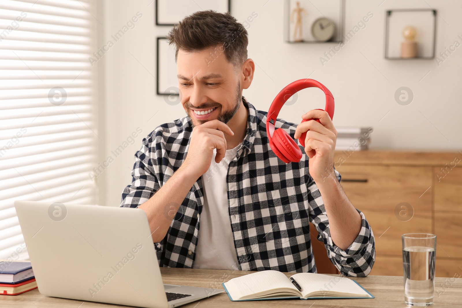 Photo of Man studying on laptop at home. Online translation course