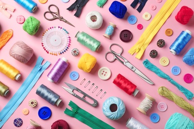 Photo of Composition with threads and sewing accessories on color background, flat lay