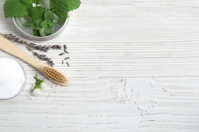 Photo of Flat lay composition with toothbrush and herbs on white wooden table. Space for text